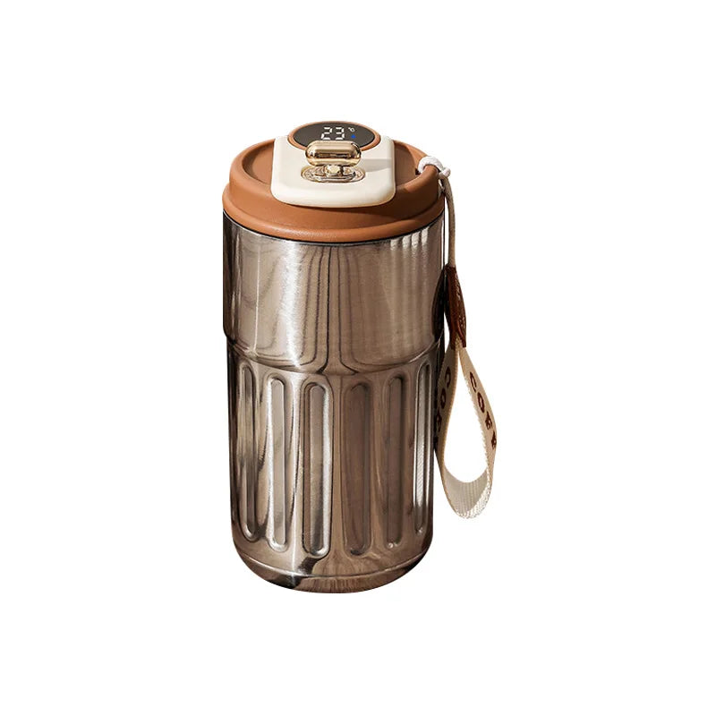 Stainless steel travel coffee mug with brown lid, digital temperature display, and carrying strap