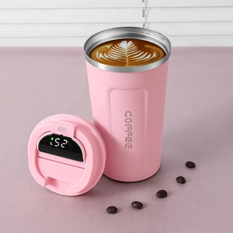 Pink insulated coffee tumbler with latte art, digital temperature lid, and coffee beans