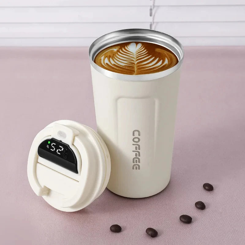 White insulated coffee tumbler with digital temperature display lid, latte art, and coffee beans