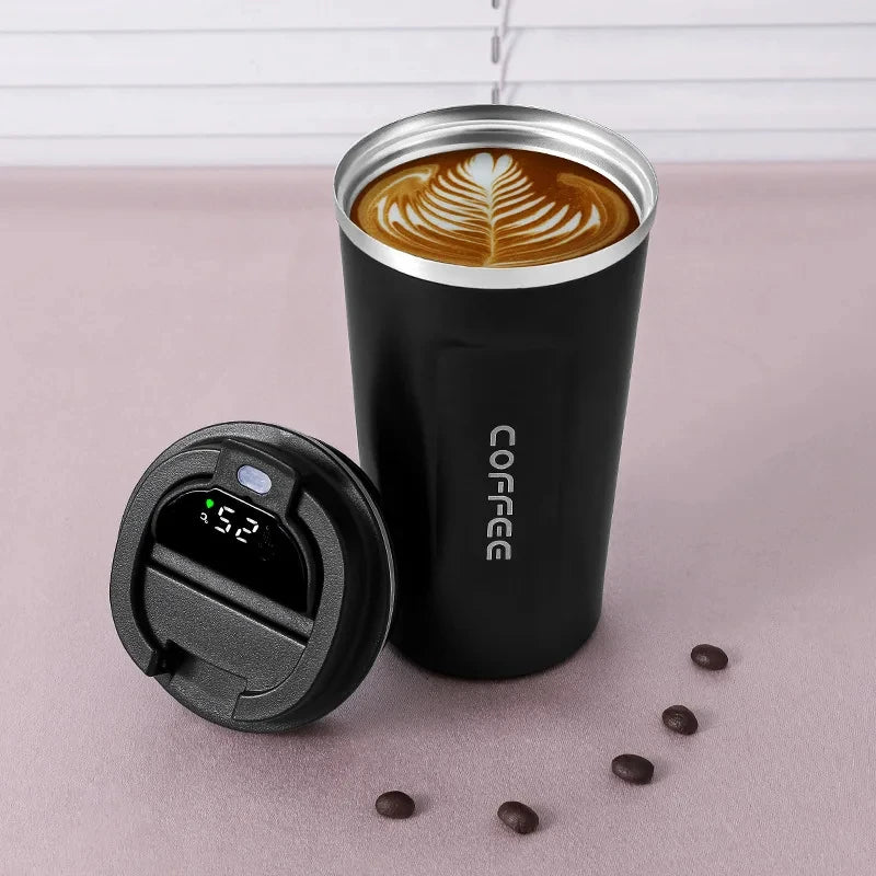 Black insulated coffee tumbler with digital temperature display lid, latte art, and coffee beans