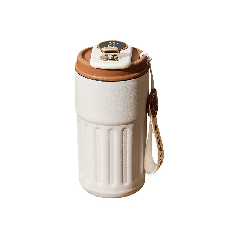 Cream and brown insulated coffee travel mug with digital temperature display and carrying strap